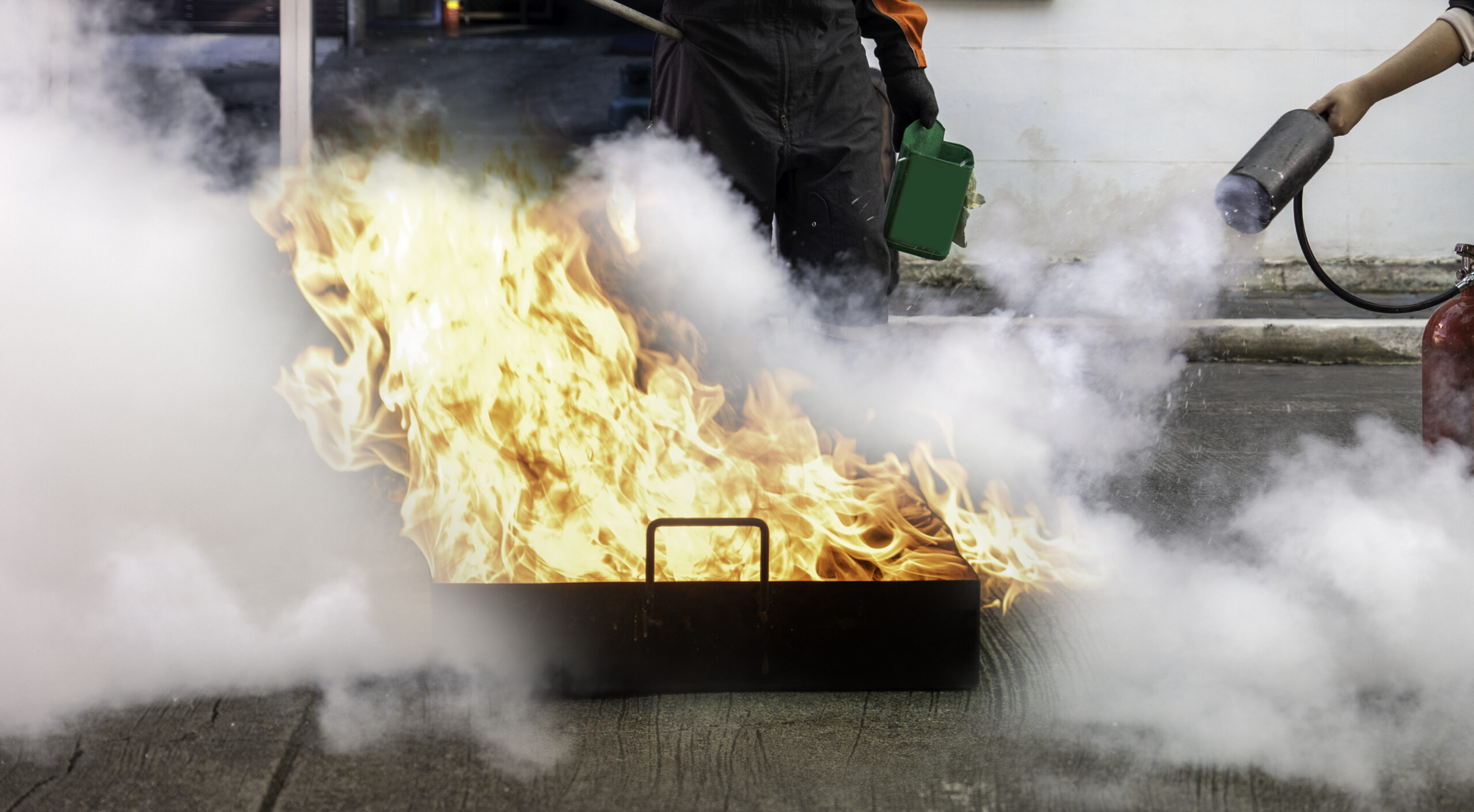 Man teaches or training how to use carbon dioxide  (CO2) fire extinguishers to extinguish fires from fuel.